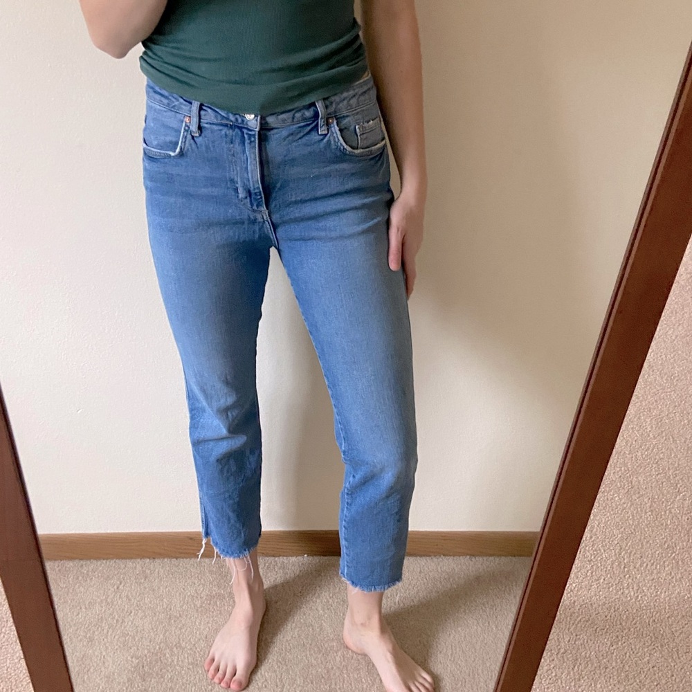 Free People denim jeans with intentionally distressed hem